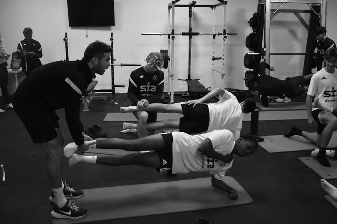Coach working hands-on with athletes